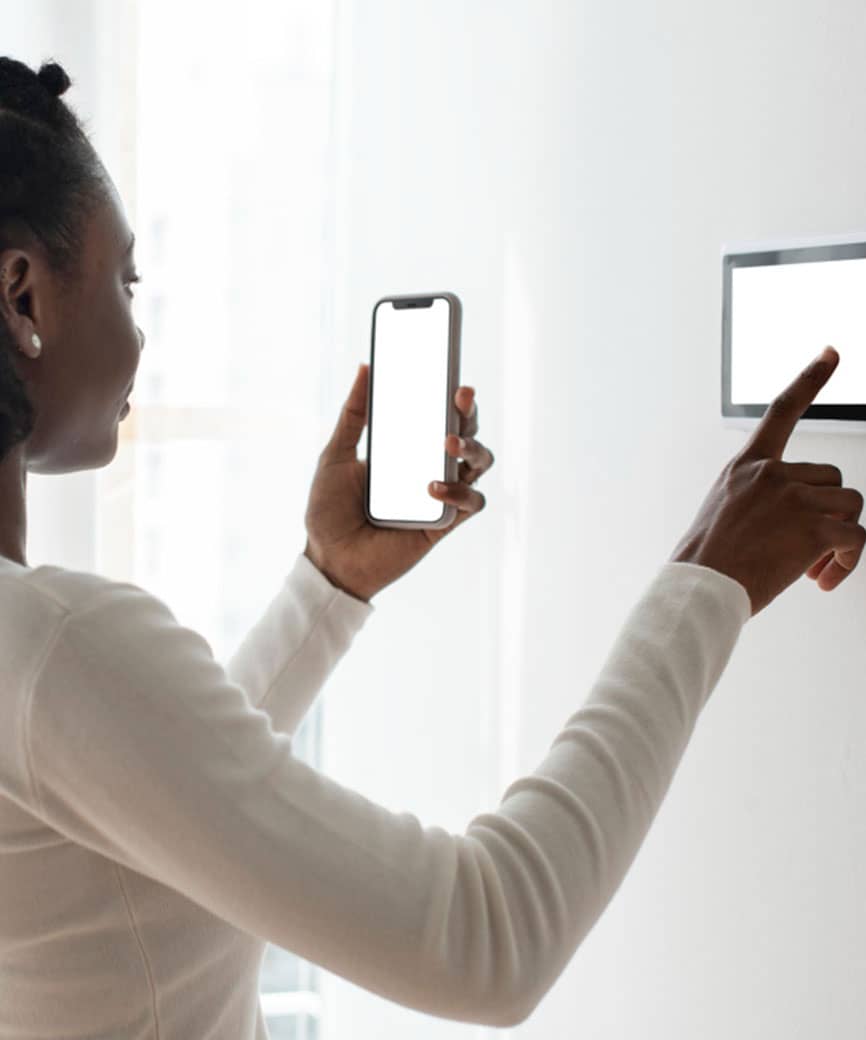 woman using a smart thermostat system