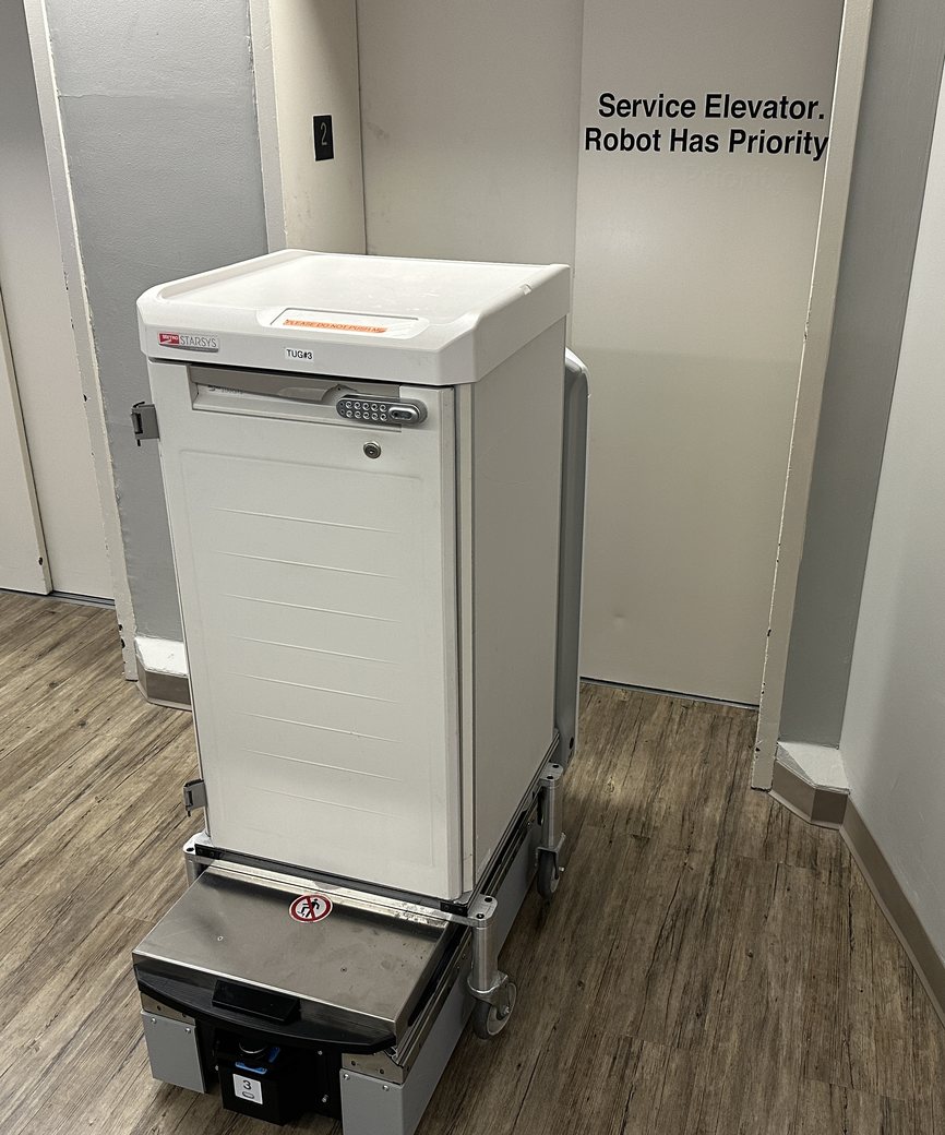 Autonomous hospital delivery robot waiting at a service elevator
